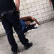 Police stand over a man passed out from the drug K2, a synthetic marijuana, in East Harlem on Sept. 02, 2015, in New York City.